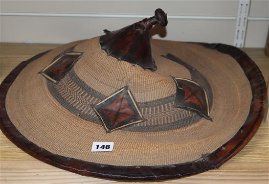 An Eastern straw and leather hat